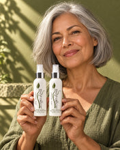 Load image into Gallery viewer, Woman with a silver bob holding two Bio Follicle Normal treatment sprays

