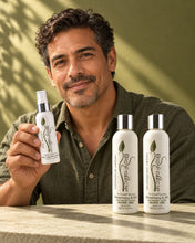 Load image into Gallery viewer, Man holding the Bio Follicle Normal spray next to the HSS shampoo and conditioner

